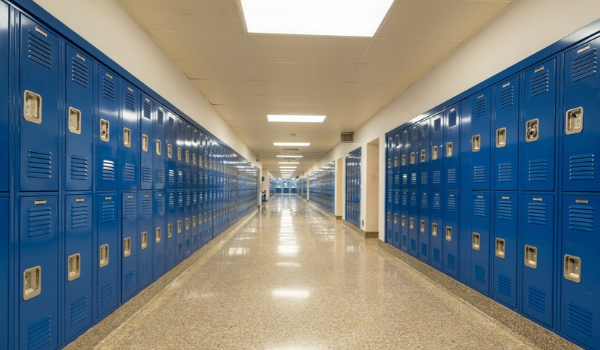A school hallway with blue lockers on either side.