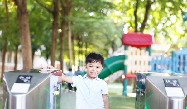 Child using key card scanner at school