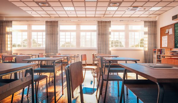 interior of a traditional school classroom with wooden floor and furniture