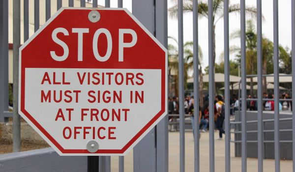 Visitor sign on the gate of school