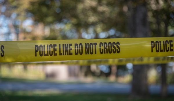 Crime scene blocked off with Police Do Not Cross Tape to restrict public access and maintain safety