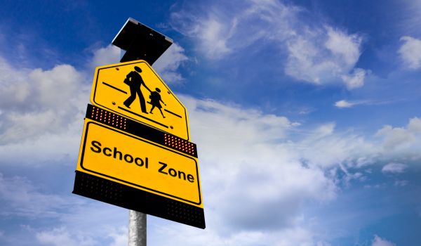 Schools Sign On Blue Sky Background