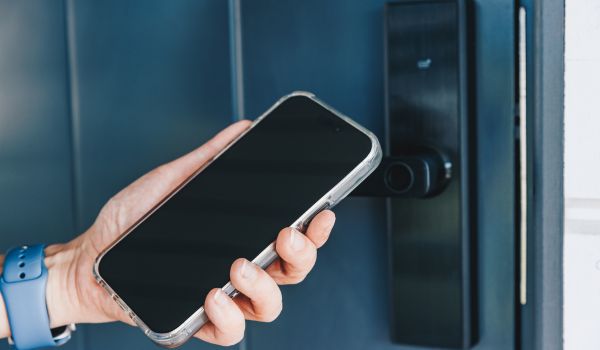 Person unlocking door with smartphone