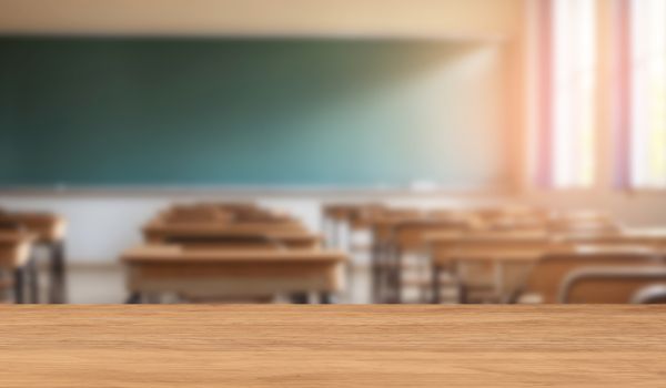 Empty classroom with desks and chairs.