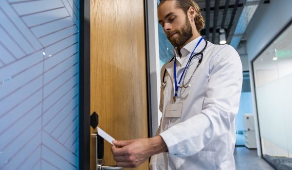Doctor use card scanner to access room