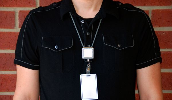 Teacher wearing ID badge with alert device