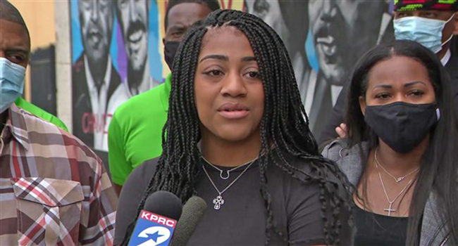 Christin Evans speaking a press conference. 