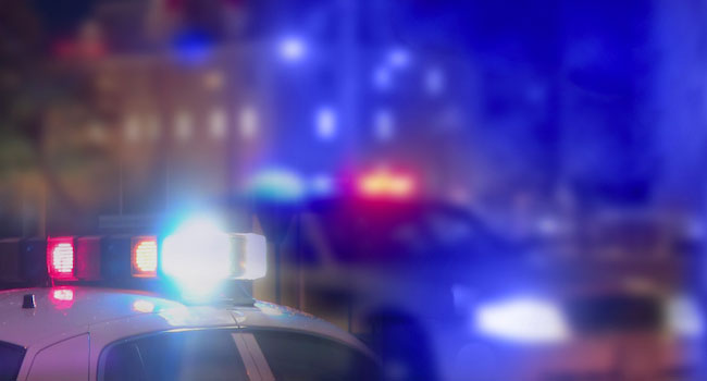 Two police cars with siren lights on. 