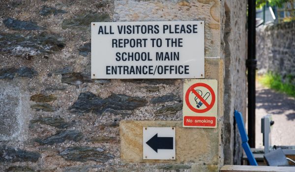All school visitors report to main office sign